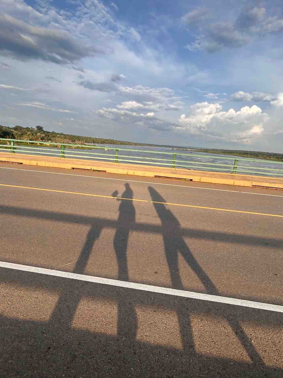shadow of two people at the roadside