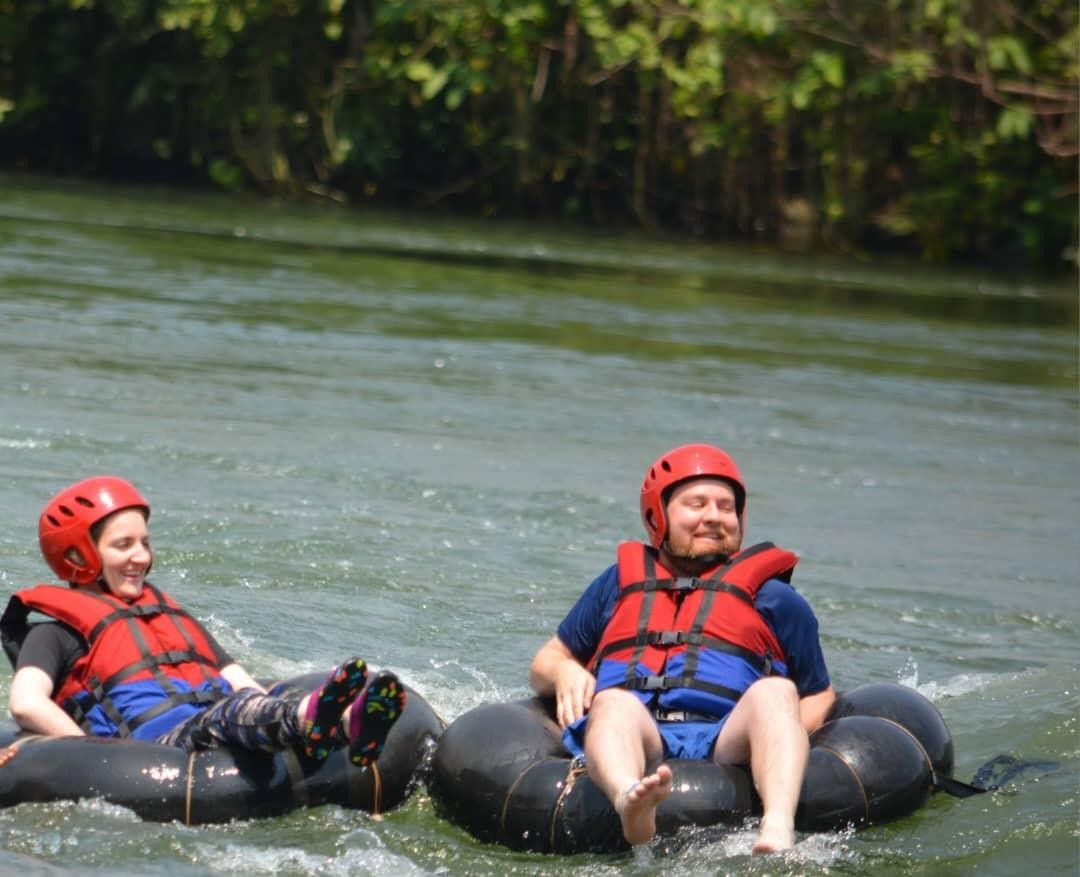 a man and a lady on floaters smilling