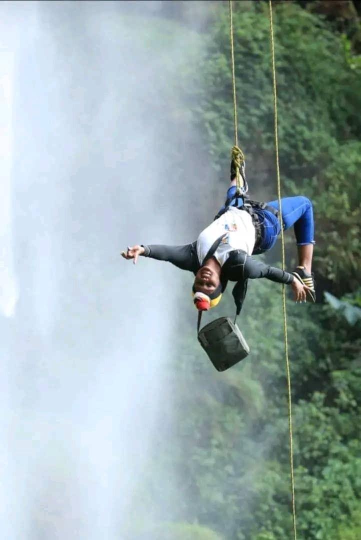 a lady smilling while on a zipline